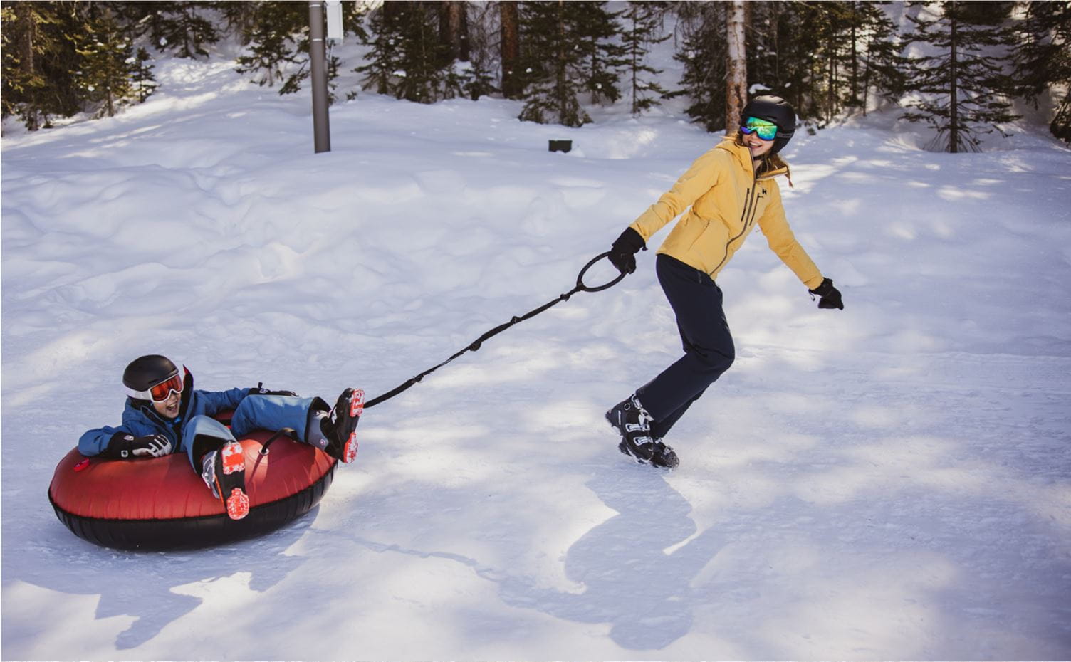 Person dragging a child on a tube at Snowmass during the winter